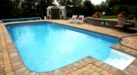 pavers-around-pool-stone-retaining-wall-clear-pool-water-inground-solar-cover