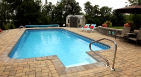 Pavers Around Pool, Stone Retaining Wall, Clear Pool Water, Inground Solar Cover