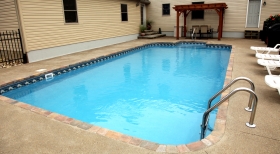 Pool with Rounded Ends, Pavers on Edge of Pool, Blue Pool Water, Steps in Pool