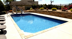 Pavers Around Pool, Stone Retaining Wall, Clear Pool Water, Pool with Slide, Gforce Slide